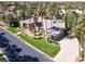 Aerial view highlighting a one-story home with a manicured lawn, mature trees, and a two-car garage at 1813 Skyline Dr, Las Vegas, NV 89117