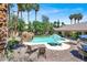 Aerial view of pool and backyard with mature trees, landscaping, and sunbathing area at 1813 Skyline Dr, Las Vegas, NV 89117