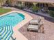 Backyard with lounge chairs and patio seating overlooking a sparkling pool at 1813 Skyline Dr, Las Vegas, NV 89117