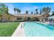 Backyard pool with lush green lawn and landscaped area with lounge seating at 1813 Skyline Dr, Las Vegas, NV 89117