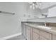 Bathroom with double sink vanity, granite countertops, framed mirror, and modern lighting fixtures at 1813 Skyline Dr, Las Vegas, NV 89117