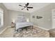 Neutral bedroom with a queen bed, ceiling fan, wood-look floors, and decorative wall art at 1813 Skyline Dr, Las Vegas, NV 89117