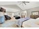 Expansive bedroom with vaulted ceiling offers a sitting area, desk space, and a luxurious massage chair at 1813 Skyline Dr, Las Vegas, NV 89117
