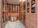 Custom walk-in closet with glass-front cabinets and ample storage space for clothes, shoes, and accessories at 1813 Skyline Dr, Las Vegas, NV 89117