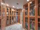 Custom walk-in closet with glass-front cabinets and built-in shelving provides a spacious storage solution at 1813 Skyline Dr, Las Vegas, NV 89117