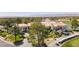Aerial view of a grand clubhouse with manicured grounds, golf carts, and access to a pristine golf course at 1813 Skyline Dr, Las Vegas, NV 89117