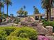 Community entrance featuring water features, manicured landscaping, and a decorative stone sign at 1813 Skyline Dr, Las Vegas, NV 89117