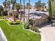 Beautiful one-story home showcasing a well-manicured lawn, mature trees, and a two-car garage at 1813 Skyline Dr, Las Vegas, NV 89117