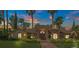 Elegant stucco home with a tile roof, mature landscaping, and a welcoming entryway at 1813 Skyline Dr, Las Vegas, NV 89117