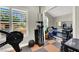 Well-equipped home gym with weights, rowing machine, and checkered rubber flooring for effective workouts at 1813 Skyline Dr, Las Vegas, NV 89117