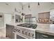 Modern kitchen features a stainless steel oven with marble countertops and a neutral color palette at 1813 Skyline Dr, Las Vegas, NV 89117
