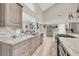 A modern kitchen with stainless steel appliances, marble countertops, and wood-look flooring at 1813 Skyline Dr, Las Vegas, NV 89117