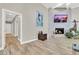 Modern living room with a fireplace and light colored wood flooring at 1813 Skyline Dr, Las Vegas, NV 89117