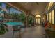 Outdoor patio with comfortable seating overlooking a pool and waterfall feature at 1813 Skyline Dr, Las Vegas, NV 89117