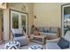 Comfortable outdoor seating area with wicker furniture and neutral-toned cushions on the covered patio at 1813 Skyline Dr, Las Vegas, NV 89117