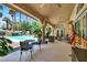 Covered patio with ceiling fans overlooks a swimming pool with waterfall and lush landscaping at 1813 Skyline Dr, Las Vegas, NV 89117