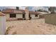 Spacious backyard with desert landscape, storage sheds, and access to the house at 1835 Banaba Ln, Las Vegas, NV 89156