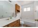 Cozy bathroom features a tub, white tile, vanity, and matching wood cabinet at 1835 Banaba Ln, Las Vegas, NV 89156