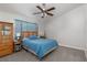 Cozy bedroom with carpet flooring, ceiling fan and a wood dresser with matching night stands at 1835 Banaba Ln, Las Vegas, NV 89156