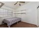 Functional bedroom with carpet flooring, open shelving and a large window providing ample natural light at 1835 Banaba Ln, Las Vegas, NV 89156