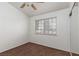 A modest bedroom with a ceiling fan, large window, and good sized closet at 1835 Banaba Ln, Las Vegas, NV 89156