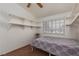 Bedroom featuring carpet flooring, floating shelving and a large window providing ample natural light at 1835 Banaba Ln, Las Vegas, NV 89156