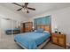 Comfortable bedroom features carpet floors, ceiling fan, mirrored closet doors, and a coordinating dresser at 1835 Banaba Ln, Las Vegas, NV 89156