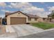 Charming single-story house featuring a red tile roof, a well-manicured lawn, and an attached two car garage at 1835 Banaba Ln, Las Vegas, NV 89156