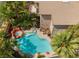 Aerial view highlighting a pool, outdoor seating, hot tub with rock features, and tropical landscaping at 2008 Aspen Oak St, Las Vegas, NV 89134