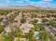 Scenic aerial shot featuring an inviting community near mountains, showcasing lush landscaping and a pool at 2008 Aspen Oak St, Las Vegas, NV 89134