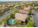 Aerial view showcases pool with spa, lush landscaping, and the neighborhood's proximity to urban amenities at 2008 Aspen Oak St, Las Vegas, NV 89134