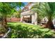 Backyard with manicured lawn, patio area for outdoor seating, and mature trees providing shade and privacy at 2008 Aspen Oak St, Las Vegas, NV 89134