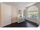 Charming bedroom with hardwood floors, an arched window, and a decorative dresser at 2008 Aspen Oak St, Las Vegas, NV 89134