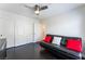 A bedroom featuring a black futon, dark wood flooring, and a ceiling fan at 2008 Aspen Oak St, Las Vegas, NV 89134
