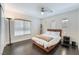 Comfortable bedroom featuring wood floors, a ceiling fan, and natural light at 2008 Aspen Oak St, Las Vegas, NV 89134