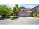 Charming two-story home featuring mature trees, a tile roof, and an attached two-car garage at 2008 Aspen Oak St, Las Vegas, NV 89134