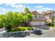 Beautiful two-story home with a three-car garage and lush landscaping at 2008 Aspen Oak St, Las Vegas, NV 89134
