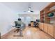 Home office with custom built-in cabinetry and wood flooring, perfect for remote work at 2008 Aspen Oak St, Las Vegas, NV 89134