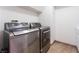 Modern stainless steel washer and dryer set in tiled laundry room at 2008 Aspen Oak St, Las Vegas, NV 89134