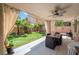 Relaxing covered patio, great for outdoor dining and entertaining, with ceiling fan and view of the manicured lawn at 2008 Aspen Oak St, Las Vegas, NV 89134