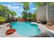 Gorgeous backyard pool surrounded by lush palm trees, offering a tranquil oasis for relaxation and recreation at 2008 Aspen Oak St, Las Vegas, NV 89134