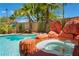 Stunning backyard pool and spa with rock waterfall feature, surrounded by tropical landscaping and palm trees at 2008 Aspen Oak St, Las Vegas, NV 89134