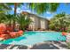 Stunning backyard pool with rock waterfall feature, lush landscaping, and exterior view of the two-story home at 2008 Aspen Oak St, Las Vegas, NV 89134