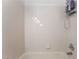 The shower over tub is tiled with a light color scheme and simple faucet at 2008 Aspen Oak St, Las Vegas, NV 89134