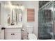 Modern bathroom featuring white vanity, shower with blue subway tile and wood accents at 2107 Desert Woods Dr, Henderson, NV 89012