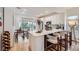 Modern kitchen with white cabinets, quartz countertops, stainless steel appliances, and a breakfast bar at 2107 Desert Woods Dr, Henderson, NV 89012