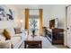 Comfortable living room features stylish furniture, window with natural light and TV at 2107 Desert Woods Dr, Henderson, NV 89012