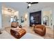 Stylish living room featuring a modern fireplace, hardwood floors, and chic furniture at 2107 Desert Woods Dr, Henderson, NV 89012