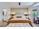 Comfortable bedroom featuring a king bed, stylish wallpaper and en suite bathroom access at 2107 Desert Woods Dr, Henderson, NV 89012