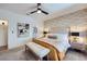Comfortable bedroom featuring a king bed, stylish wallpaper and en suite bathroom access at 2107 Desert Woods Dr, Henderson, NV 89012
